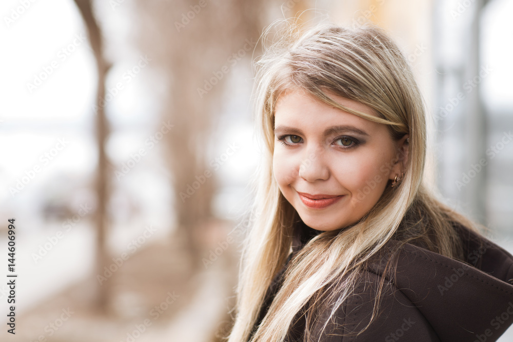 Portrait of young girl in urban background. Portrait of young girl in urban background.