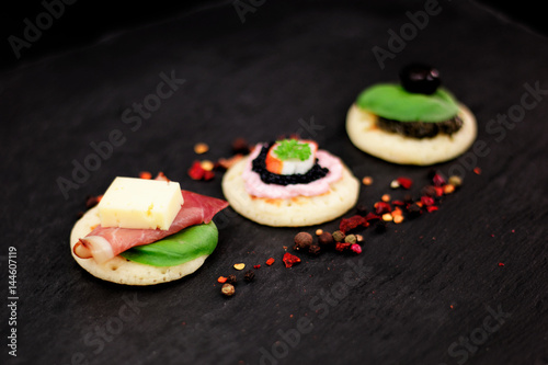 Fototapeta Naklejka Na Ścianę i Meble -  Homemade pancake canapes on slate stone plate for finger food party