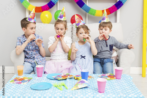 Happy group of children having fun at birthday party. Happy birthday