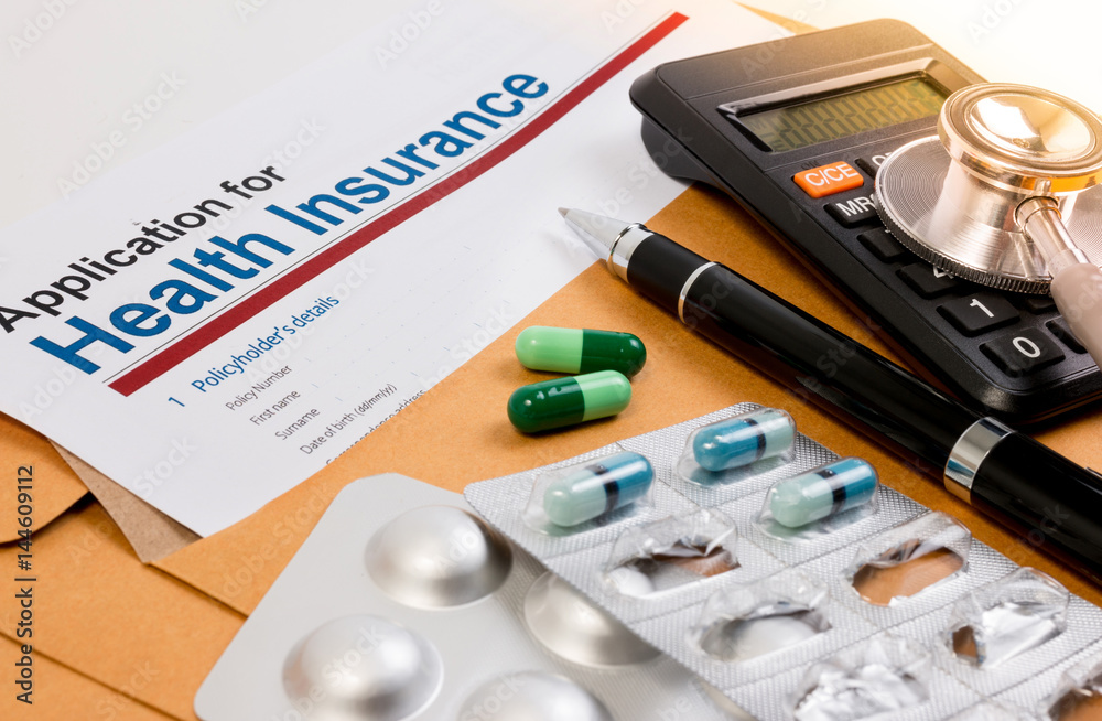 Application form for health insurance, paperwork, questionnaire, pen, tablet, calculator, envelope and stethoscope. Calculate for health insurance concept. Application form for health insurance, paperwork, questionnaire, pen, tablet, calculator, envelope and stethoscope. Calculate for health insurance concept.