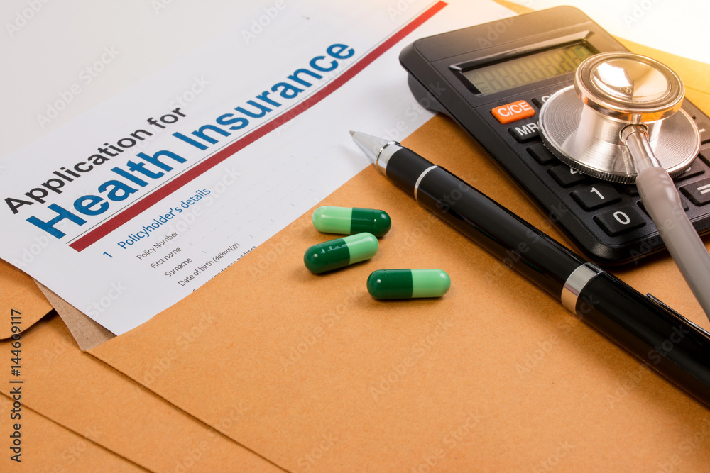 Application form for health insurance, paperwork, questionnaire, pen, tablet, calculator, envelope and stethoscope. Calculate for health insurance concept. Application form for health insurance, paperwork, questionnaire, pen, tablet, calculator, envelope and stethoscope. Calculate for health insurance concept.