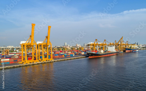 container ship in import export and business logistic.By crane ,Trade Port , Shipping, cargo to harbor, Aerial view, Top view.