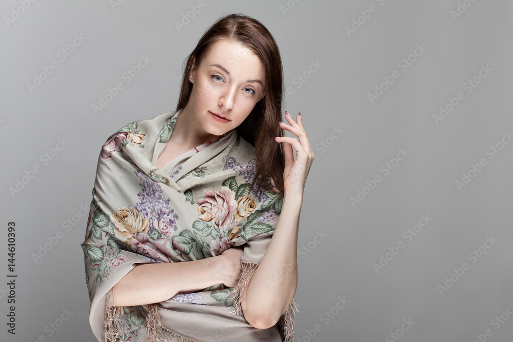 Portrait of cute girl in a shawl isolated on gray background. Portrait of cute girl in a shawl isolated on gray background.