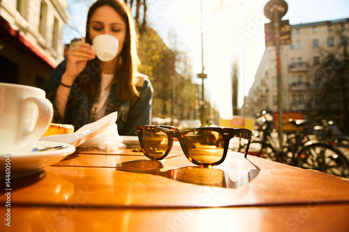 A girl sitting with coffee in a cafe of Berlin photo
