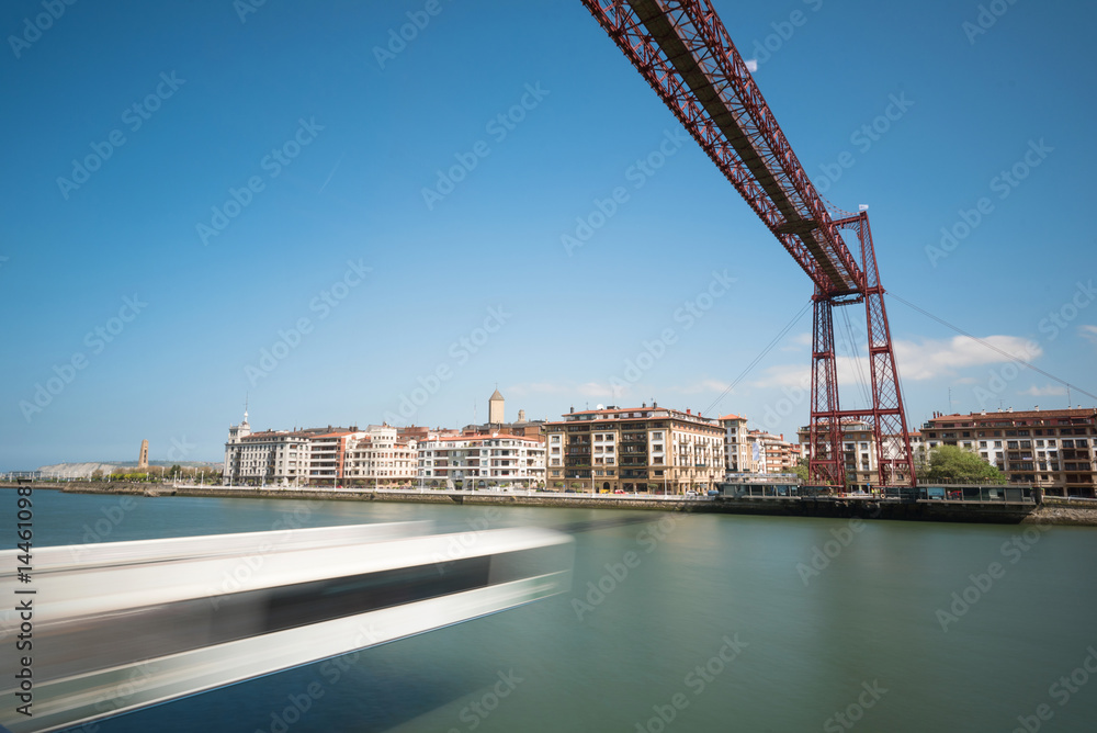 Fototapeta premium Daylight long exposure of Vizcaya hanging bridge and Nervion river in Portugalete, Bilbao, Spain.