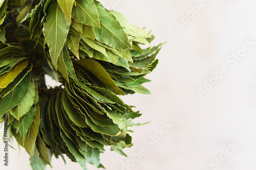 Dry green laurel leaves ready for cooking. branch of laurel bay leaves on a paper photo