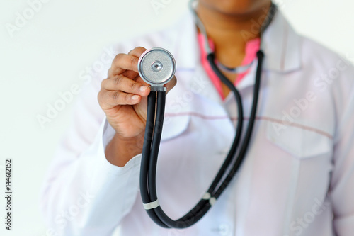 Stethoscope in focus in hand of doctor