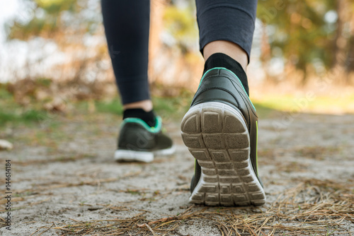 A girl in tights and sports shoes at the start, before running, outdoors