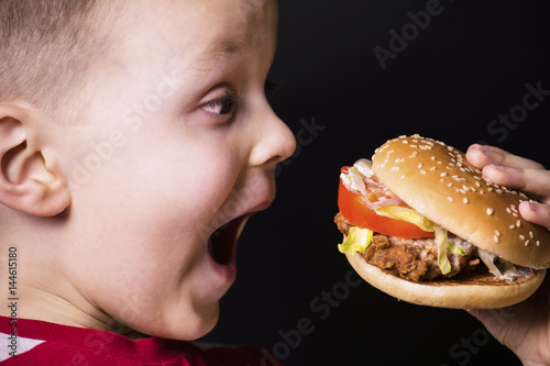 Funny boy eating a hamburger