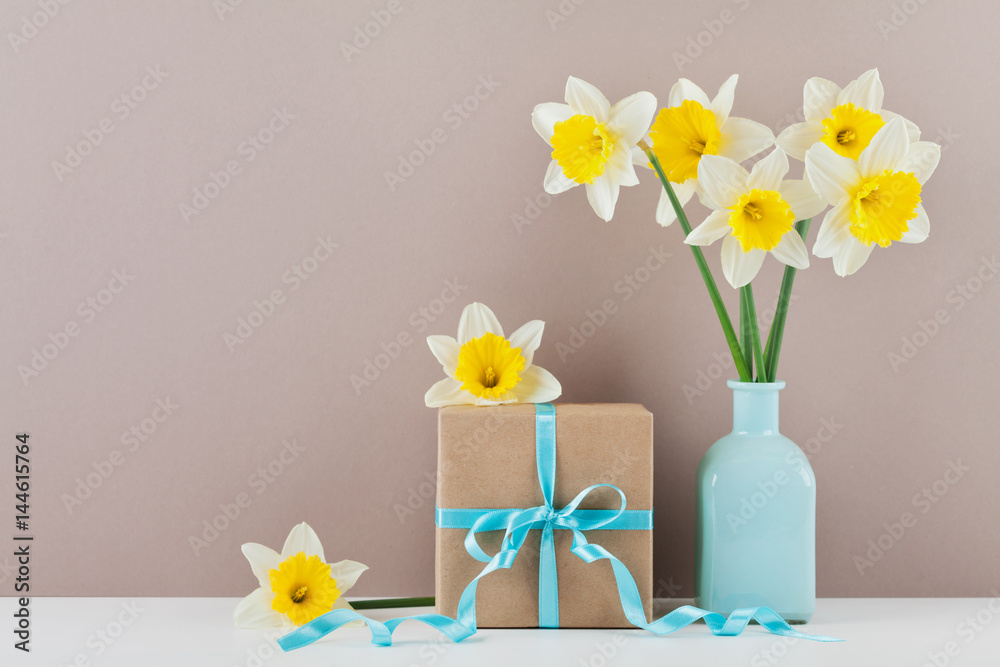 Narcissus or daffodil flowers in vase and gift box for greeting on mother day.