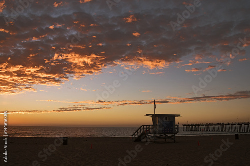 Lifeguard station with american flag on Hermosa beach at sunset © aragami