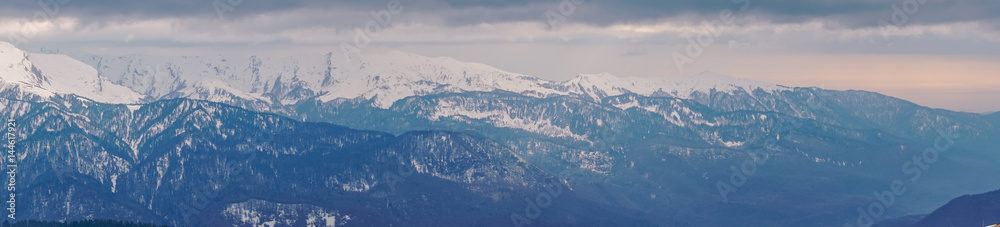 Panoramic view of the Caucasus mountains in the cloudy winter weather