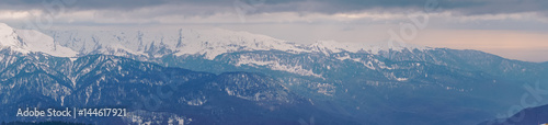 Panoramic view of the Caucasus mountains in the cloudy winter weather