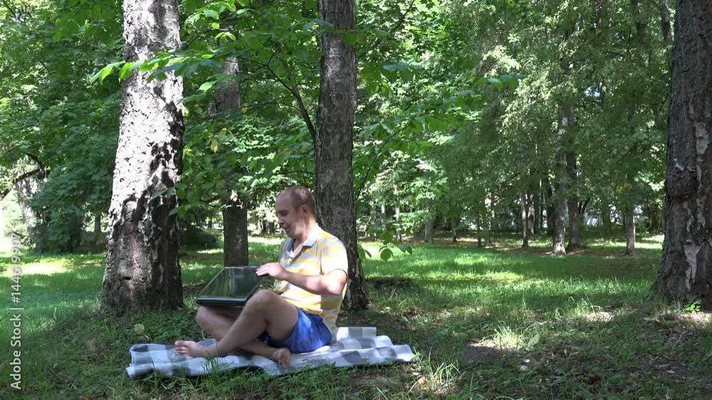 Freelancer self employed man using laptop in nature. 4K Freelancer self employed man using laptop in nature. 4K