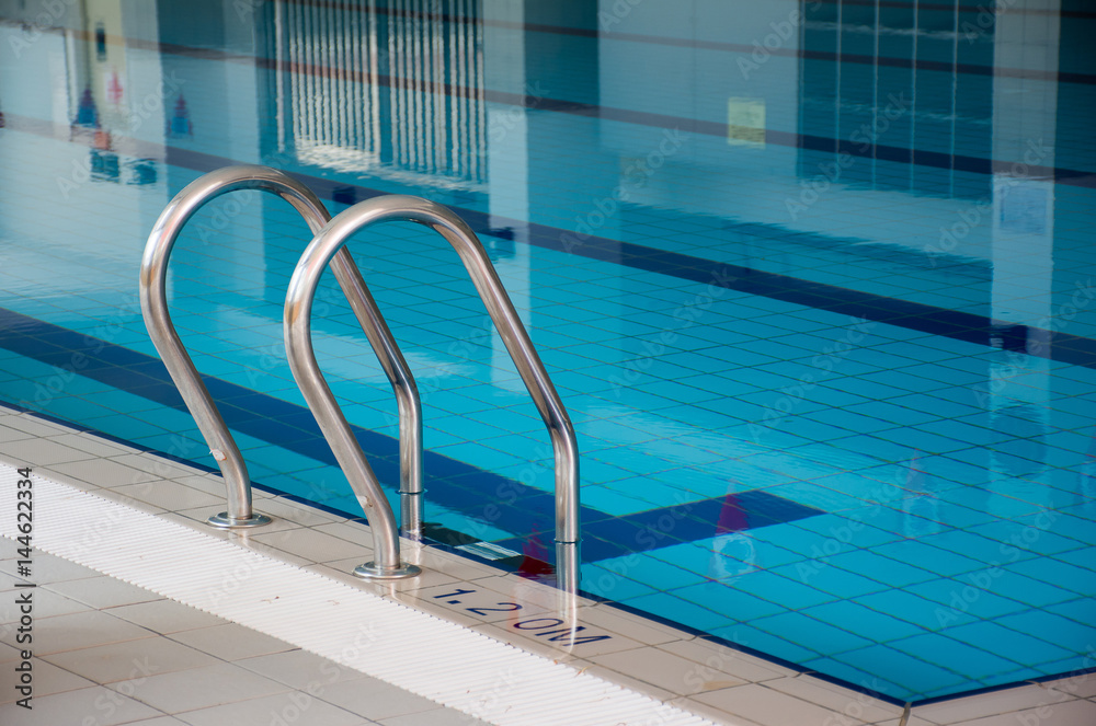 Soft focused picture of stainless steel Stairs down to the pool,with Reflection in the pool Soft focused picture of stainless steel Stairs down to the pool,with Reflection in the pool