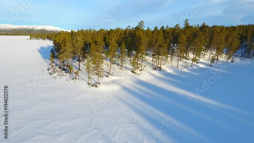 Wallpaper Mural Low level flight over a norwegian lake and pine forest in winter  Torontodigital.ca
