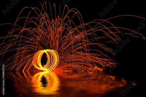 Man playing fire baton in Texture background