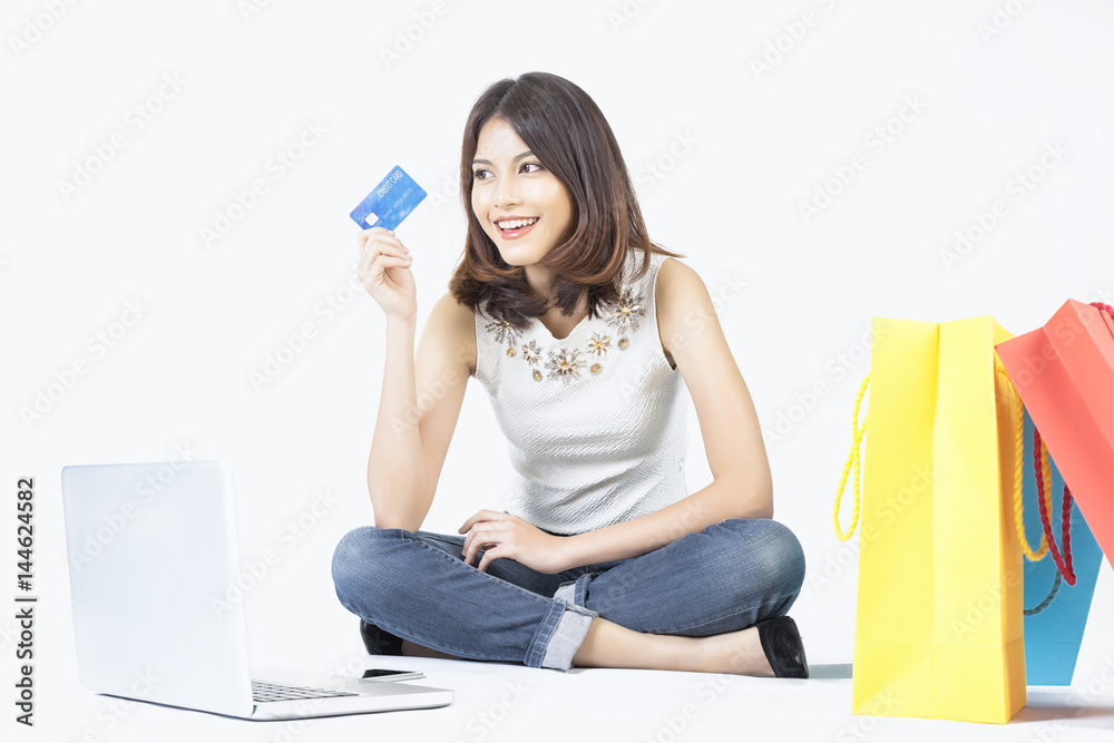beautiful woman shopping online with laptop and credit card on white background beautiful woman shopping online with laptop and credit card on white background