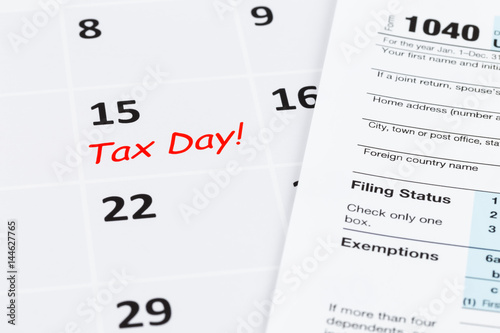 Tax day on calendar and tax form