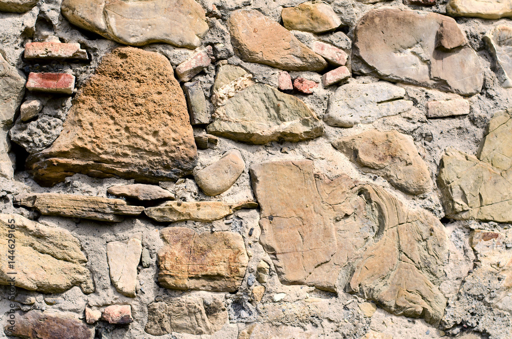 The texture of old stones together with cement. The texture of old stones together with cement.