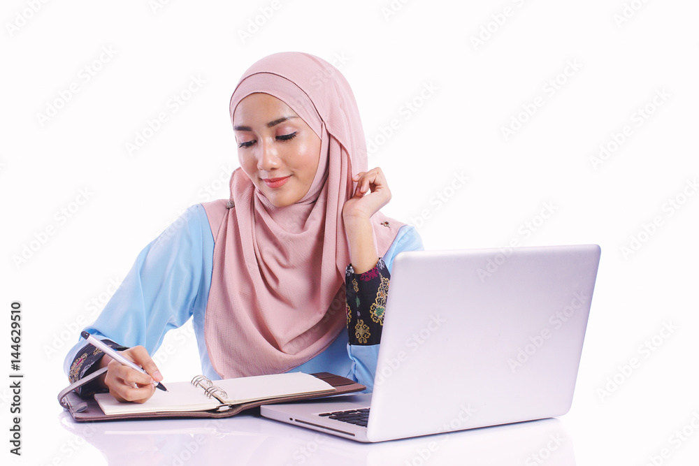 Pretty woman wearing hijab in front of laptop search and doing office work with different face expression isolated in white background - office, business, finance and work station concept Pretty woman wearing hijab in front of laptop search and doing office work with different face expression isolated in white background - office, business, finance and work station concept