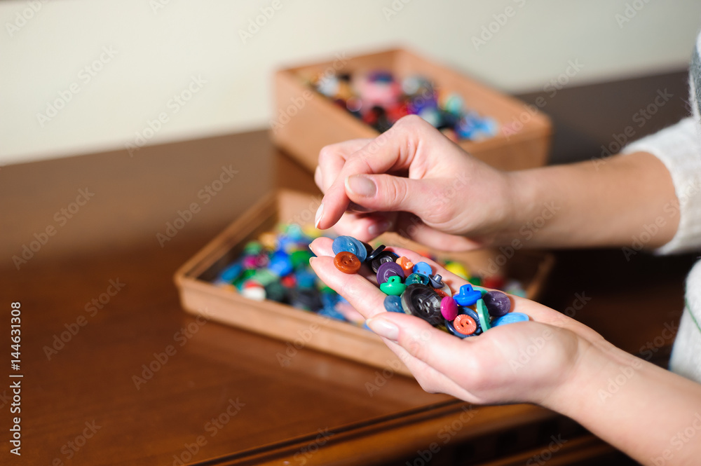 colorful sewing buttons in the hands colorful sewing buttons in the hands