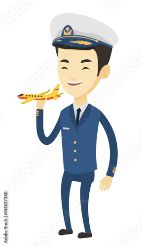 Cheerful airplane pilot with model of airplane.