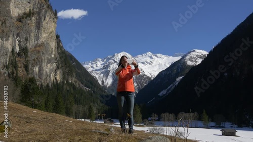 Woman taking salfie with nature photo