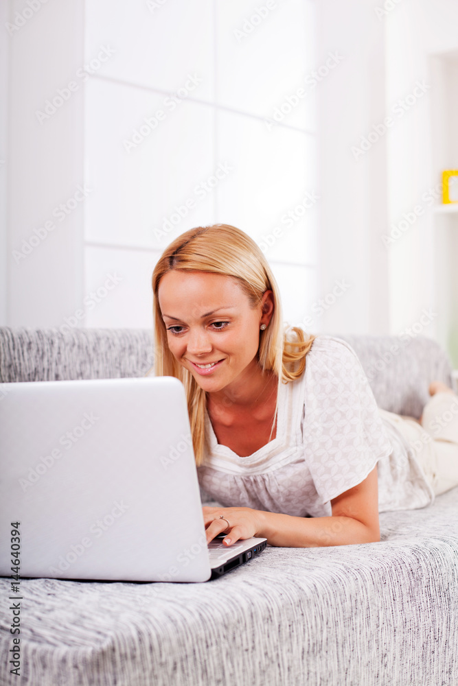 A young woman working on the laptop at home. A young woman working on the laptop at home.