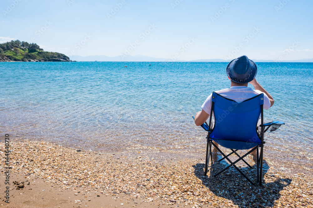 Young Traveller Sitting on the Beach Enjoying the View