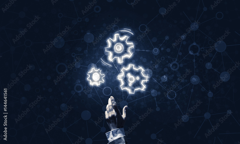 Glowing cogwheel mechanism icon on dark background as symbol of Glowing cogwheel mechanism icon on dark background as symbol of