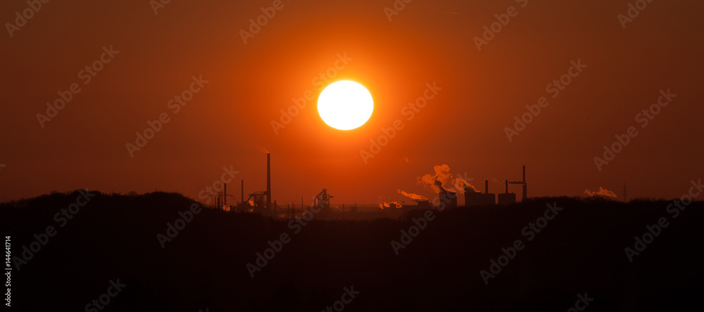 sunset behind industrial landscape, Ruhr-Area Germany