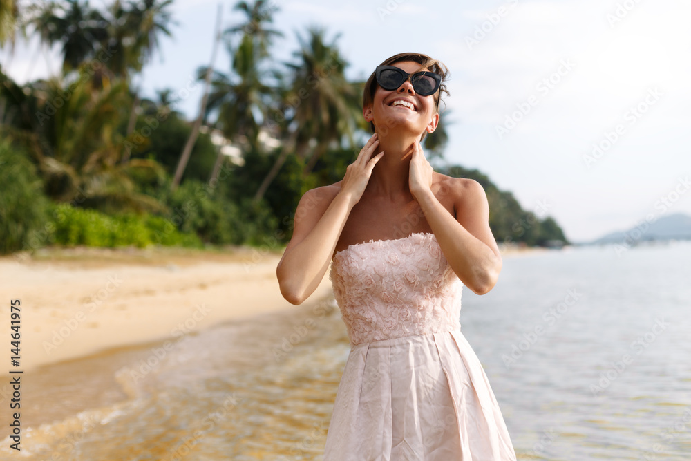 Sunny girl is posing on near the sea Sunny girl is posing on near the sea