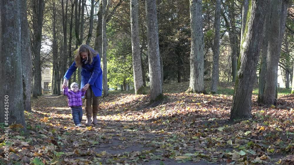 happy mother with little baby girl having fun in autumn park. 4K happy mother with little baby girl having fun in autumn park. 4K