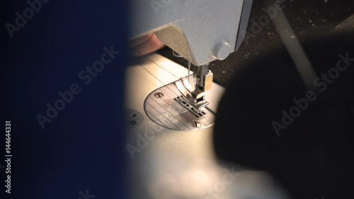 Dressmaker puts on a thread in the needle