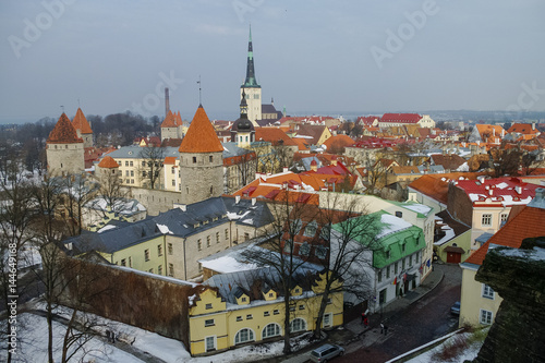 Tallinn old town winter panoramic view with fortress towers and walls, tiles roof and cathedrals spire. Estonia