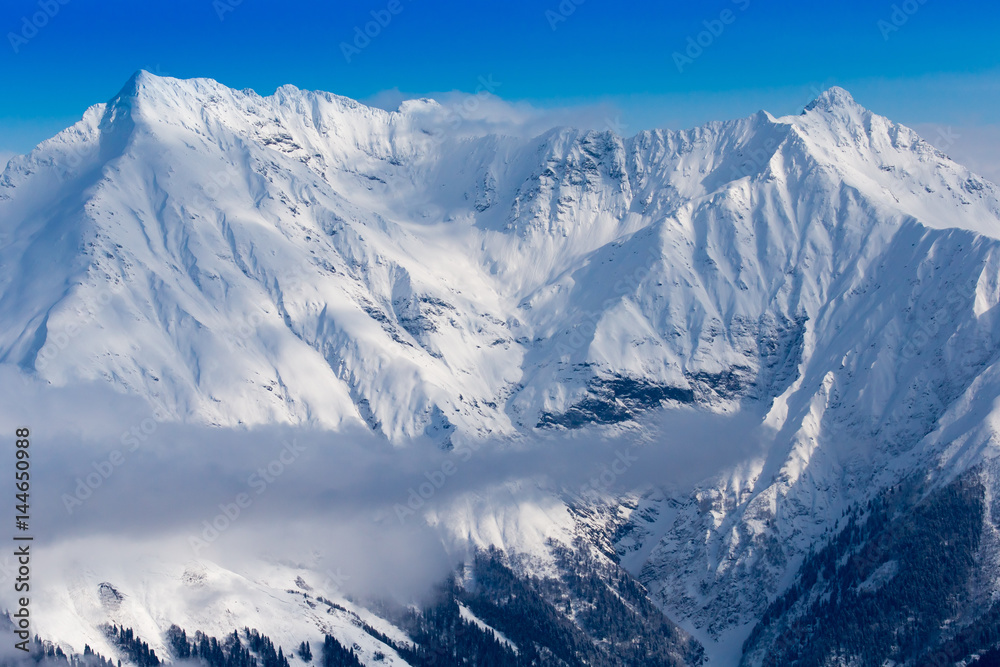 Snow mountains peaks and blue sky