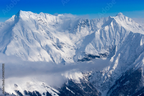 Snow mountains peaks and blue sky © Pavel Burchenko