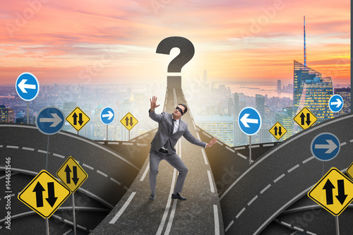 Blindfold businessman on the road unsure