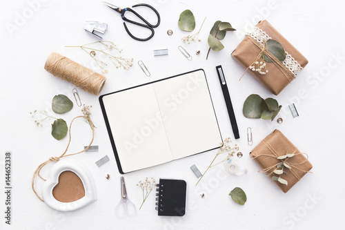 Workspace with notebook and decorations. Wedding planning concept. Flat lay 