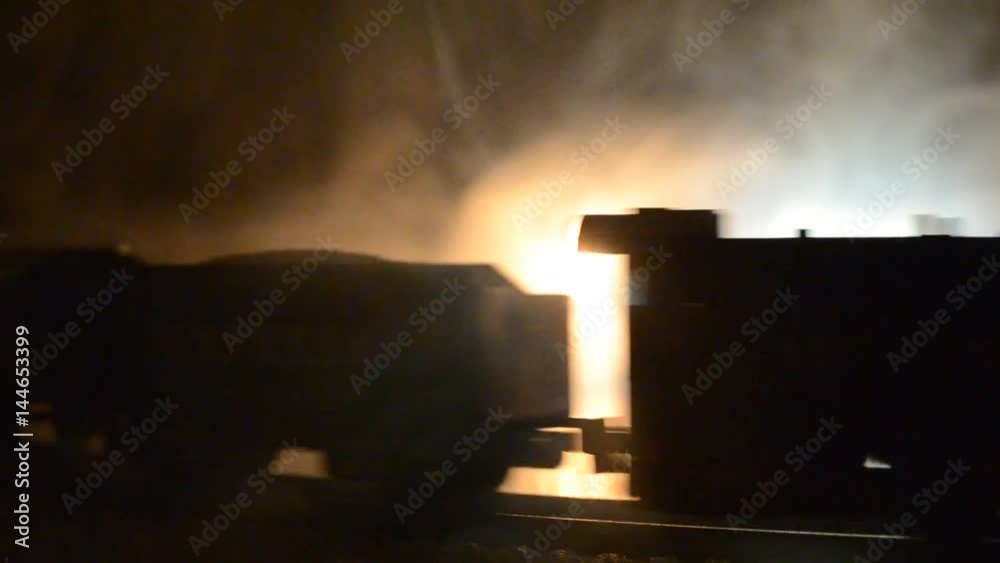 Train moving in fog. Ancient steam locomotive in night. Night train moving on railroad. orange fire background. Horror mystical scene