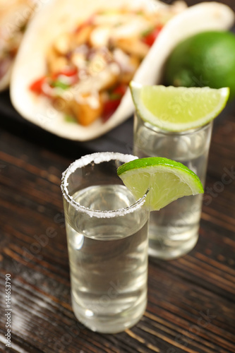 Tequila glasses with lime slices, closeup