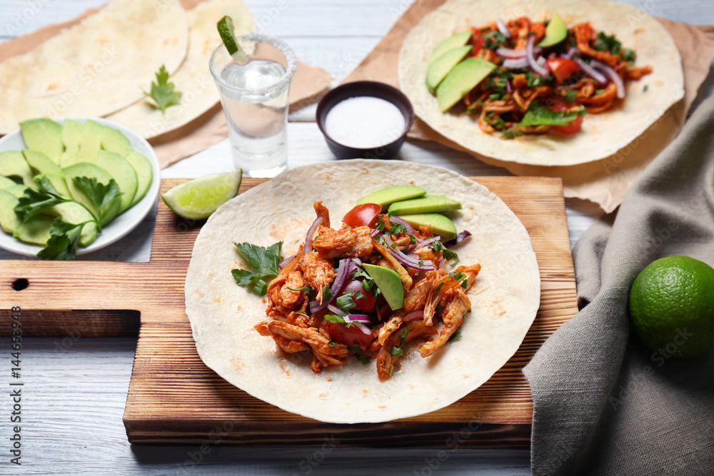 Delicious taco with tequila lime chicken on wooden board Delicious taco with tequila lime chicken on wooden board