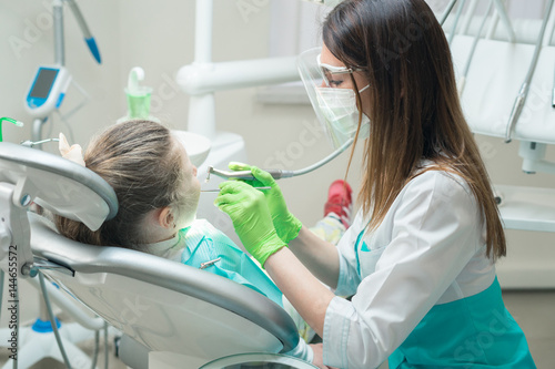dentist treating child s teeth