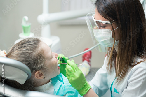 dentist treating child s teeth