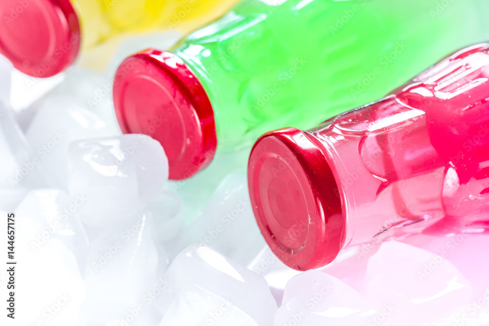 plastic bottles with fruit juice and ice space for text plastic bottles with fruit juice and ice space for text