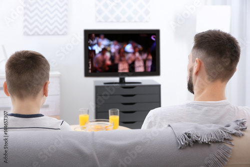 Father and son watching TV ...