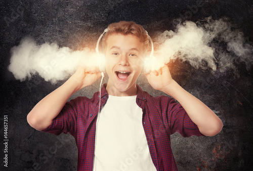 Boy listening music on ligh...