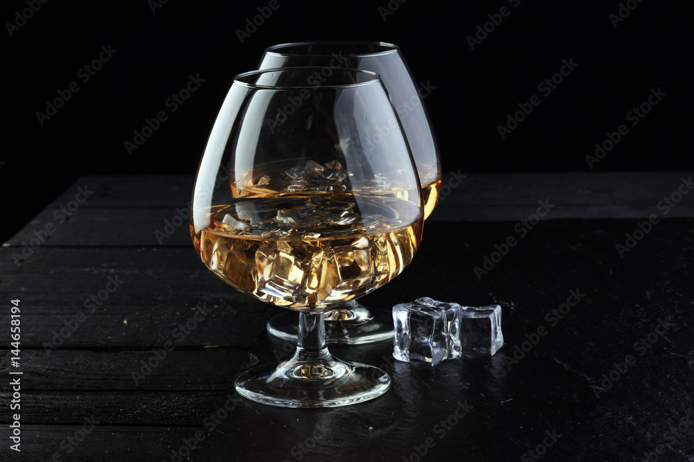 glass of whiskey with ice on a wooden glass of whiskey with ice on a wooden