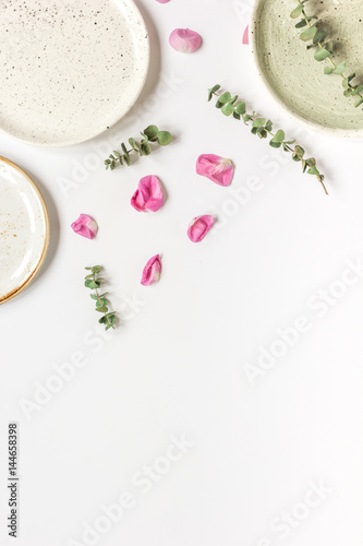rose petals and plate flat lay on woman desk top view mockup